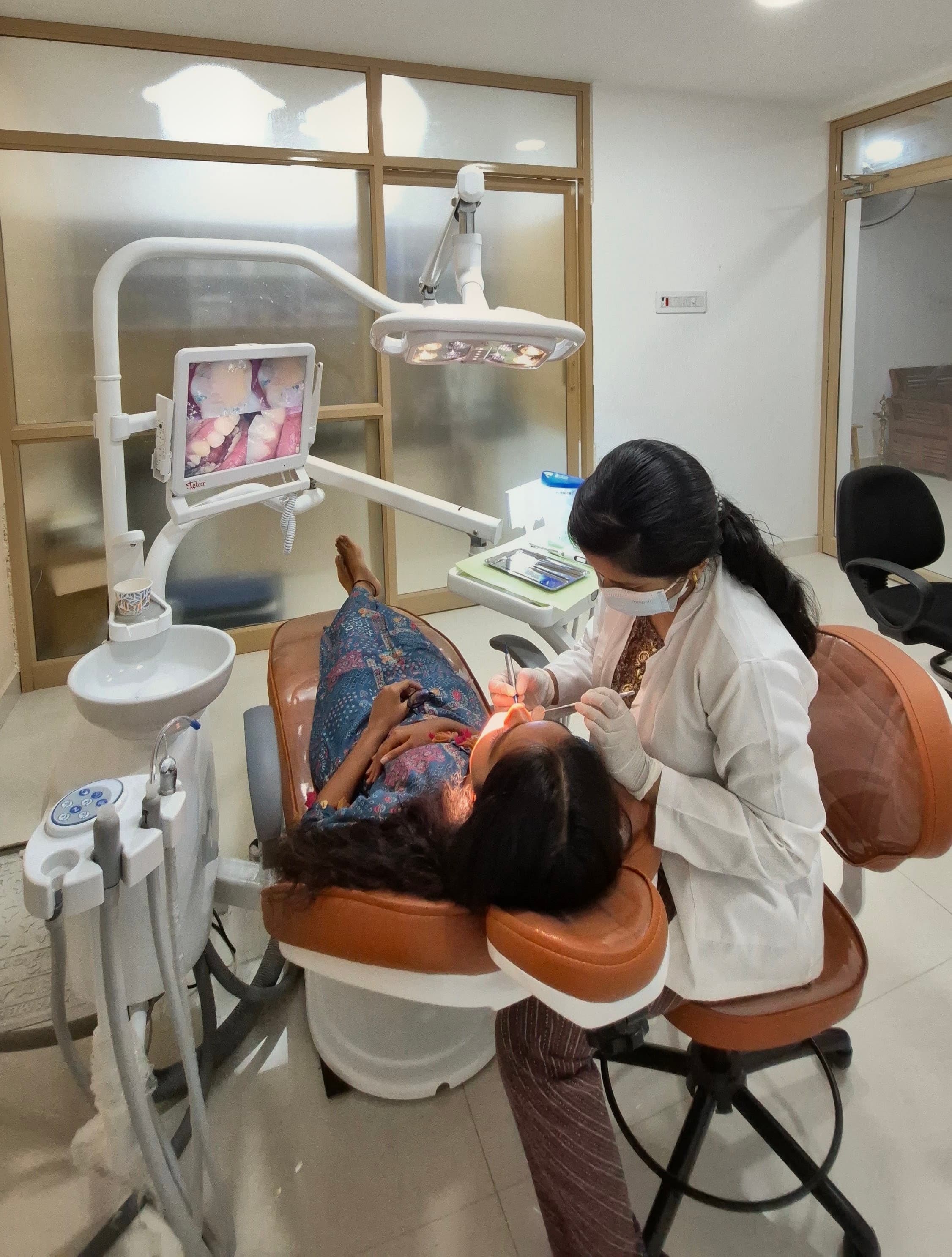 Dentist attending to a patient at Valamai Dental Care